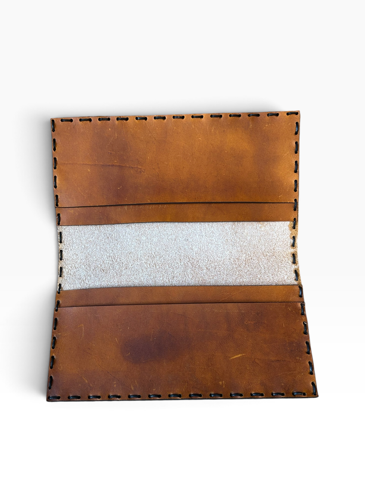 Leather checkbook cover interior showing card pockets and hand-sewn construction