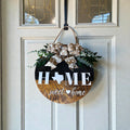 Texas Home Sweet Home round wood door hanger with polka-dot burlap bow and faux greenery on a white front door