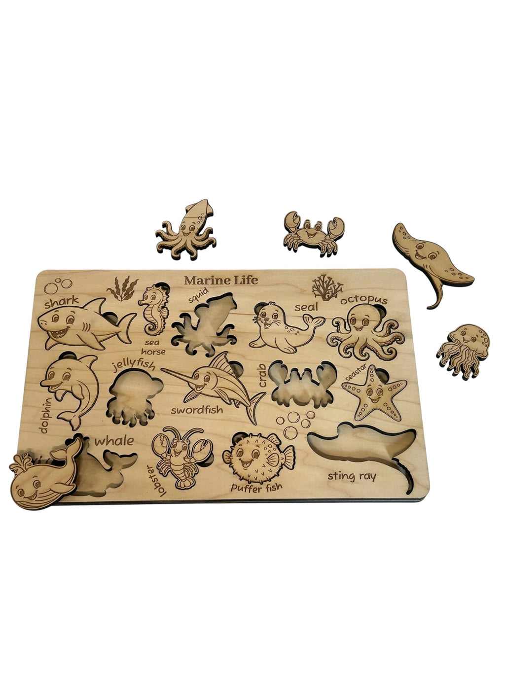 Close-up of shark, lobster, seahorse, and dolphin puzzle pieces