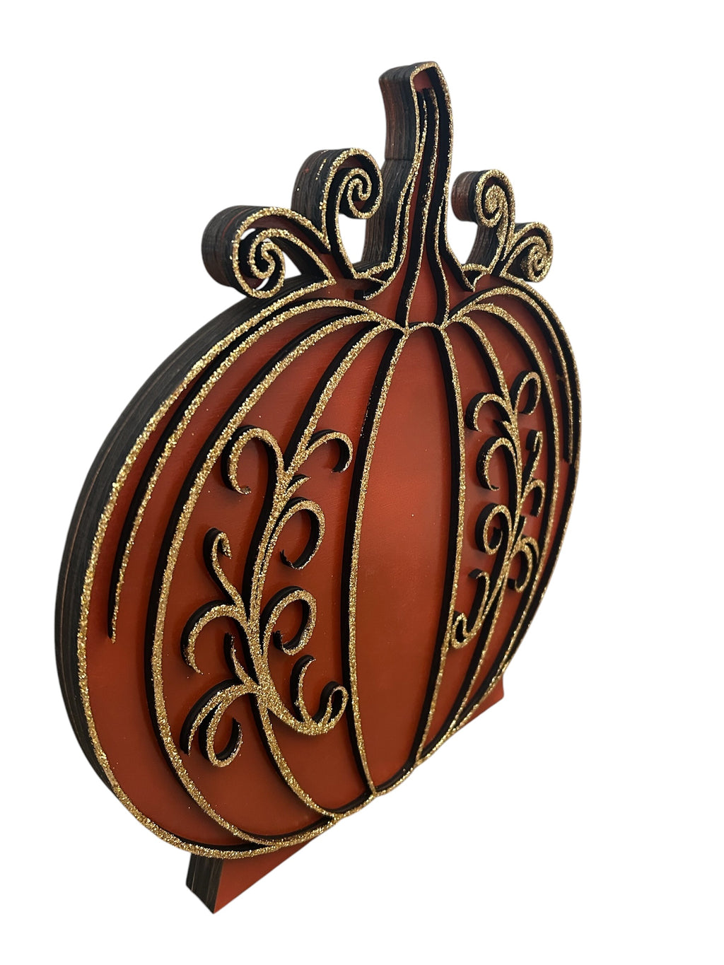 Angled view showing the layered construction of the hand-painted wood pumpkin