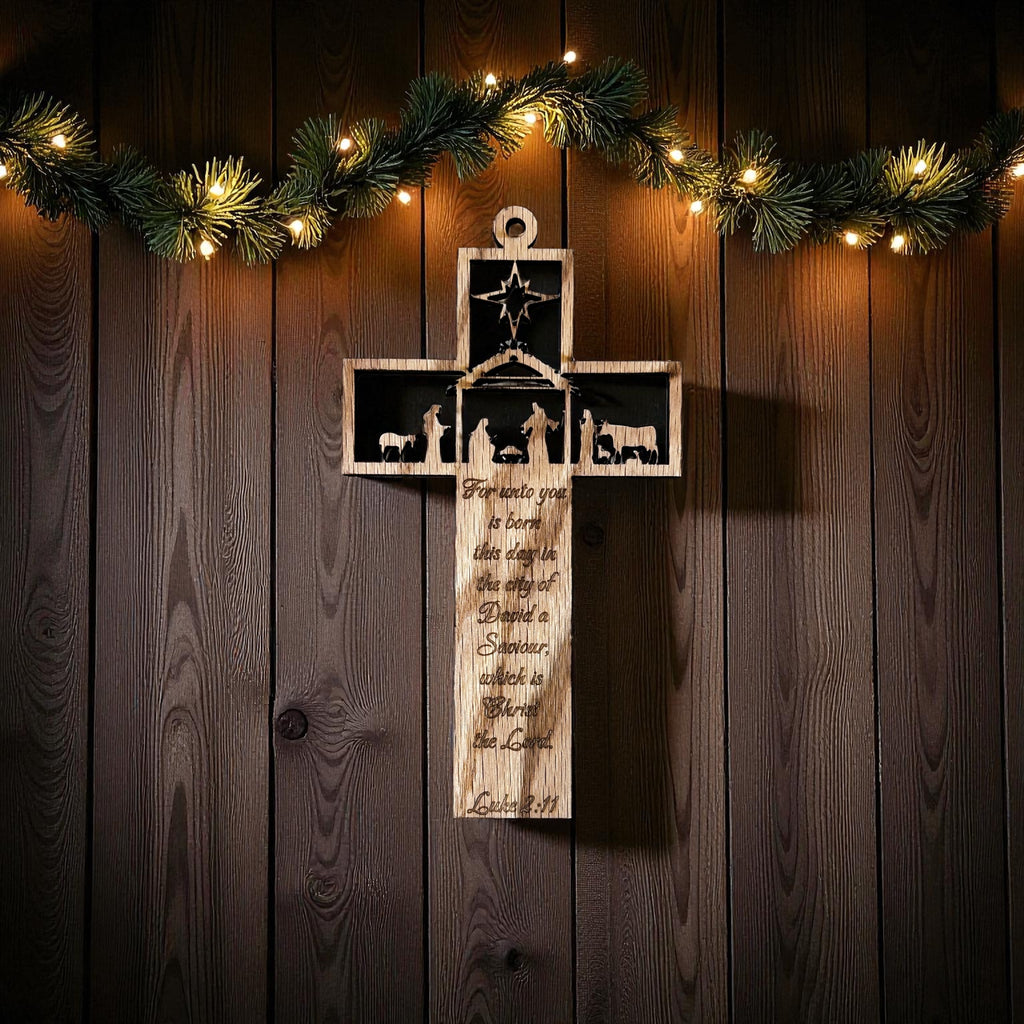 Stained maple wood cross ornament with a laser-cut nativity scene, star, and engraved Luke 2:11 scripture.
